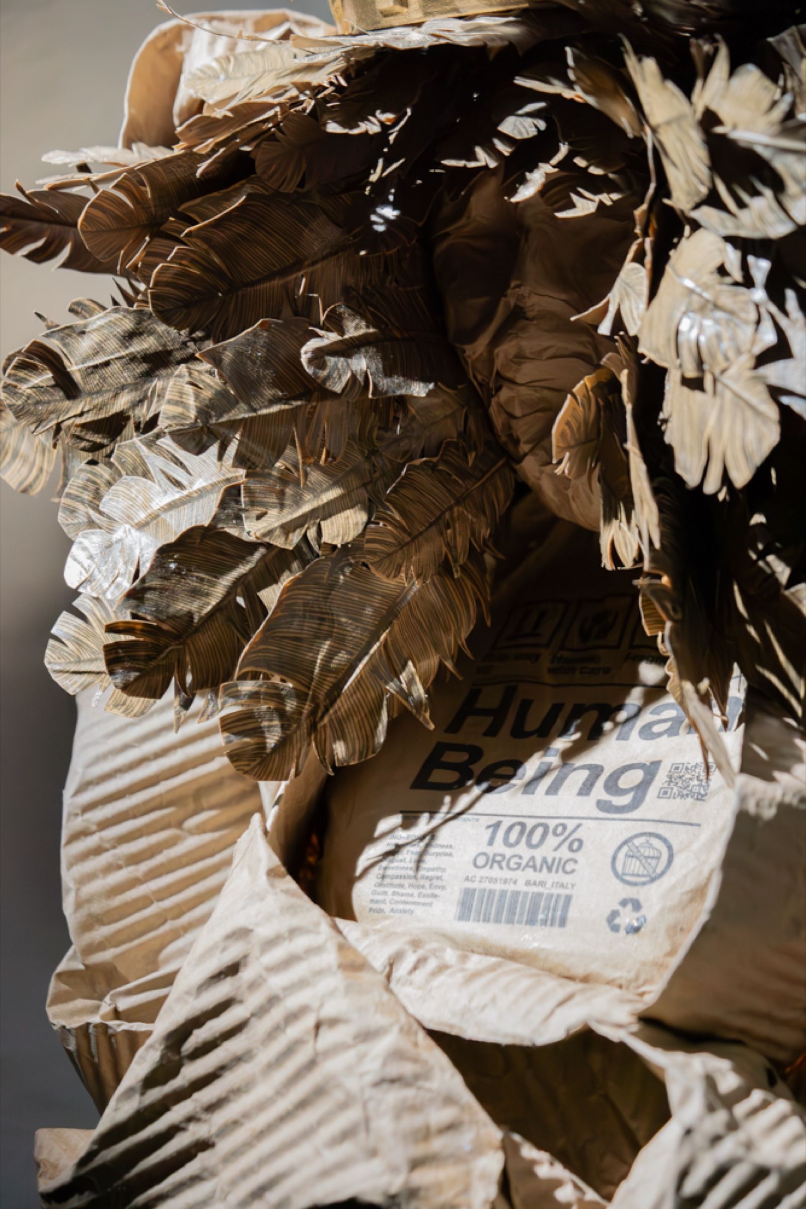 Folded and crumpled kraft paper, the material the figures are built from.